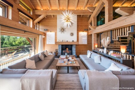 Le salon, face à sa cheminée, dans la pièce principale de ce chalet de luxe à Megève