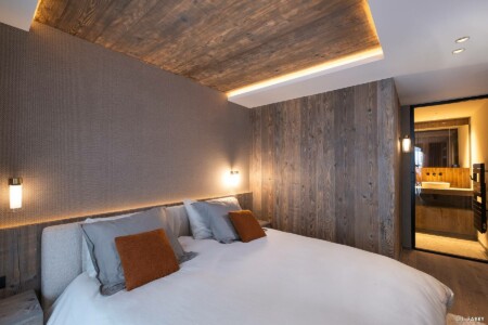 Photographie immobilière à Courchevel : chambre d'un appartement dans la résidence le Manej